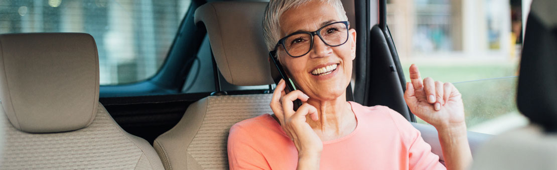 senior woman sitting in car